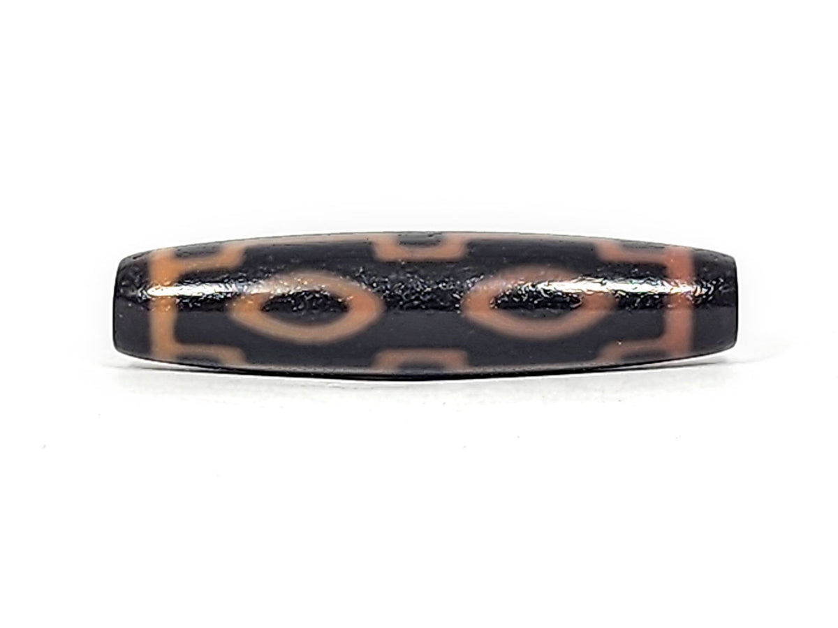 Second face of antique Four Eye dzi At-012325-4E, amber-orange four eye motif on deep dark brown agate torpedo, warm etched ring composition, 51.9mm, unretouched