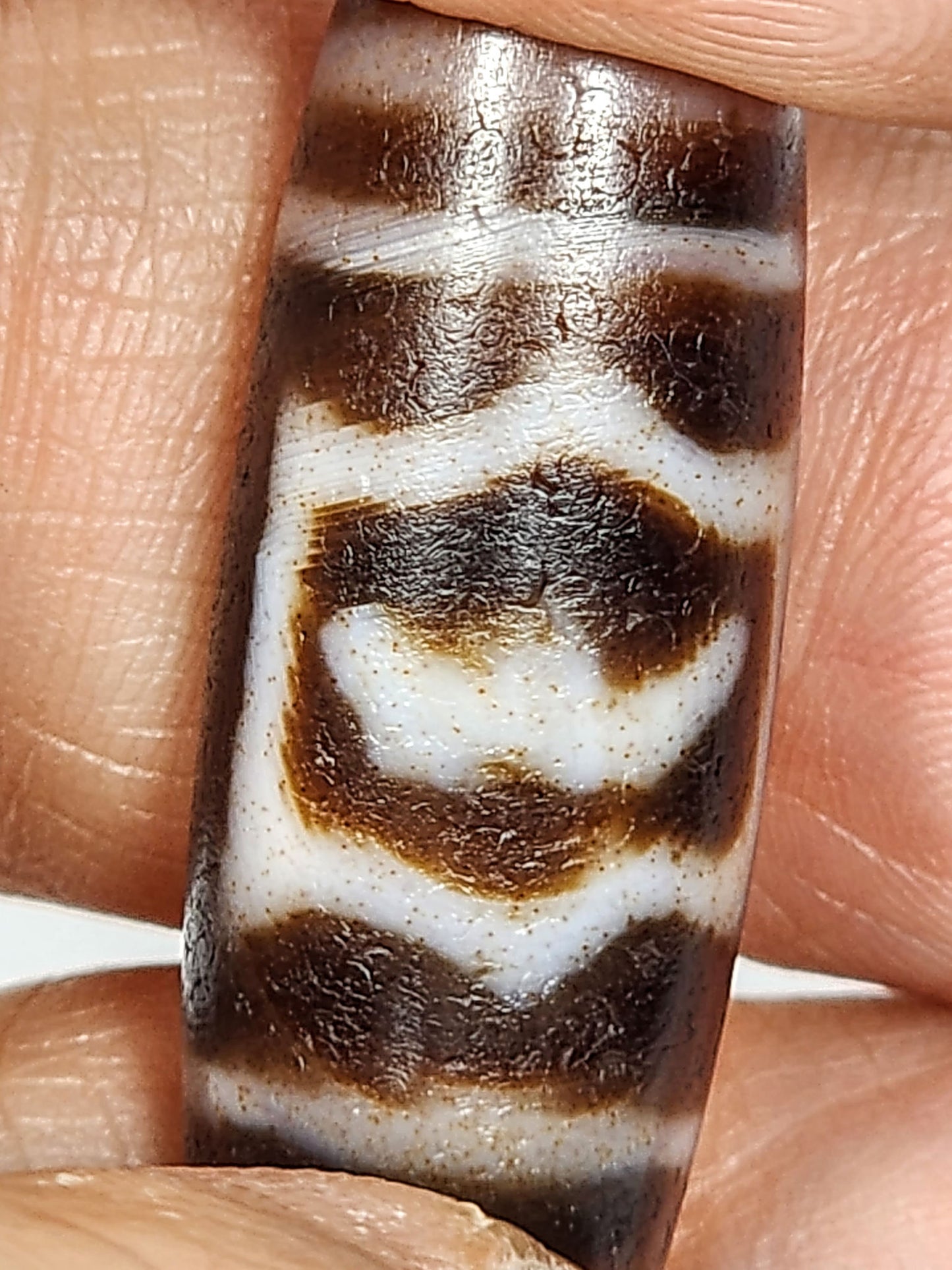 At-011425-GRD macro face B Garuda body form rust-orange cinnabar dots white zone dzi unretouched