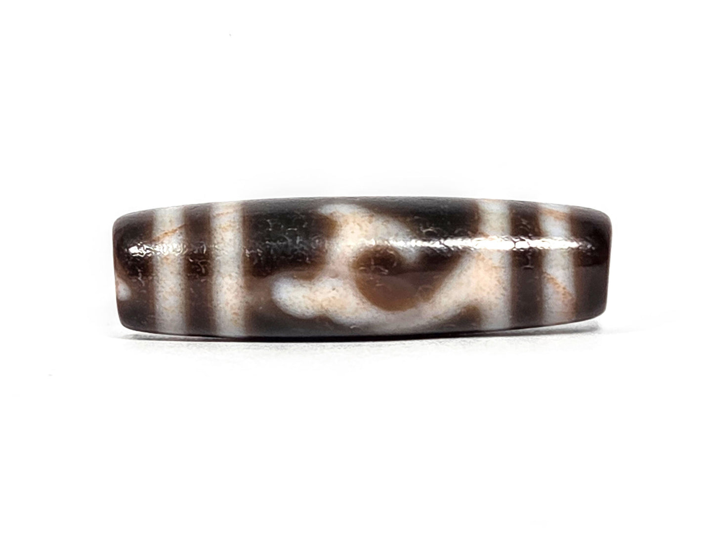 At-080426-GTBS2 antique Green Tara dzi bead 37.8×10.8mm, Face A showing scroll motif on very dark brown ground, cream lines with peach bloodspot tinge, unretouched