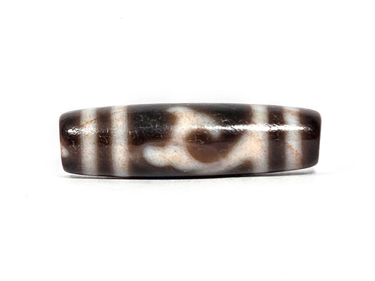 At-080426-GTBS2 antique Green Tara dzi bead 37.8×10.8mm, Face A showing scroll motif on very dark brown ground, cream lines with peach bloodspot tinge, unretouched