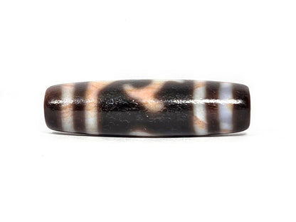 At-080426-GTBS2 antique Green Tara dzi bead 37.8×10.8mm, turn view opposite showing wave form and bloodspot-tinted cream zones in warm light, unretouched
