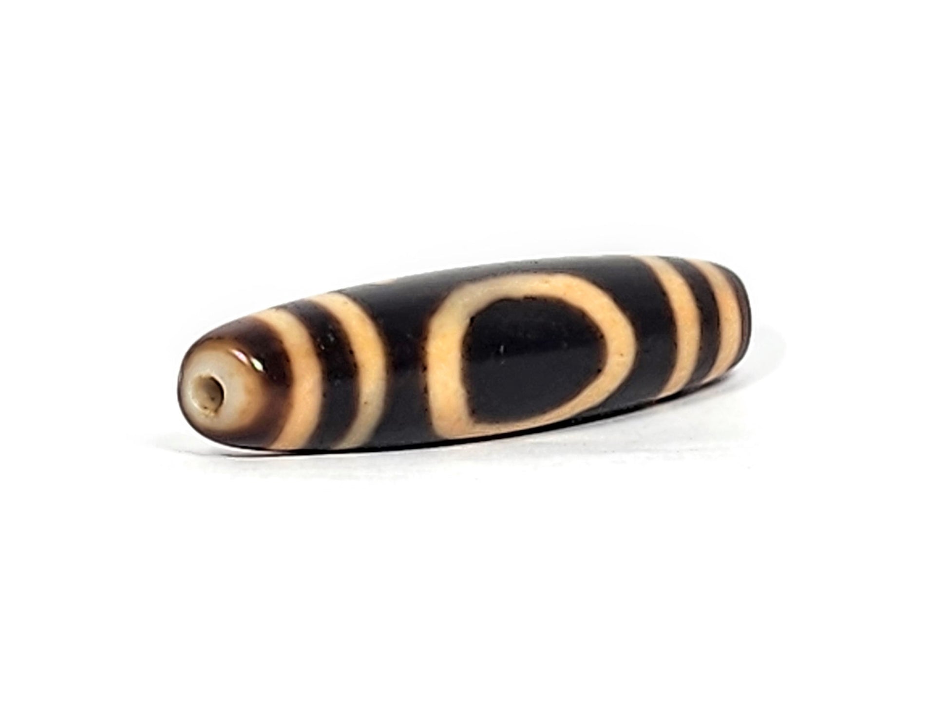 Opposite end of antique Tibetan Heaven Earth dzi bead showing drill hole and oval gate on dark brown body, At-121824-HE2