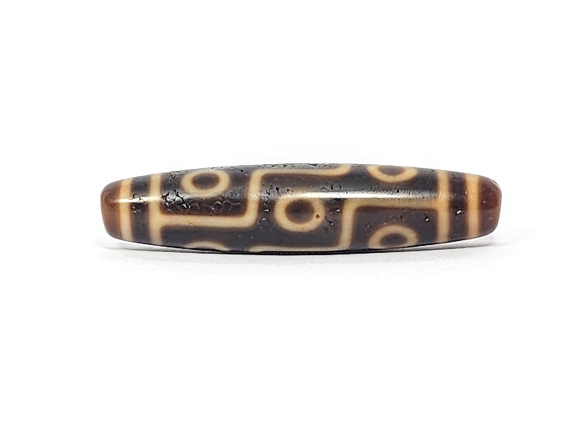 Antique Tibetan Nine Eye dzi bead face C with staggered eyes and pronounced weathered surface texture, At-051525-9E2
