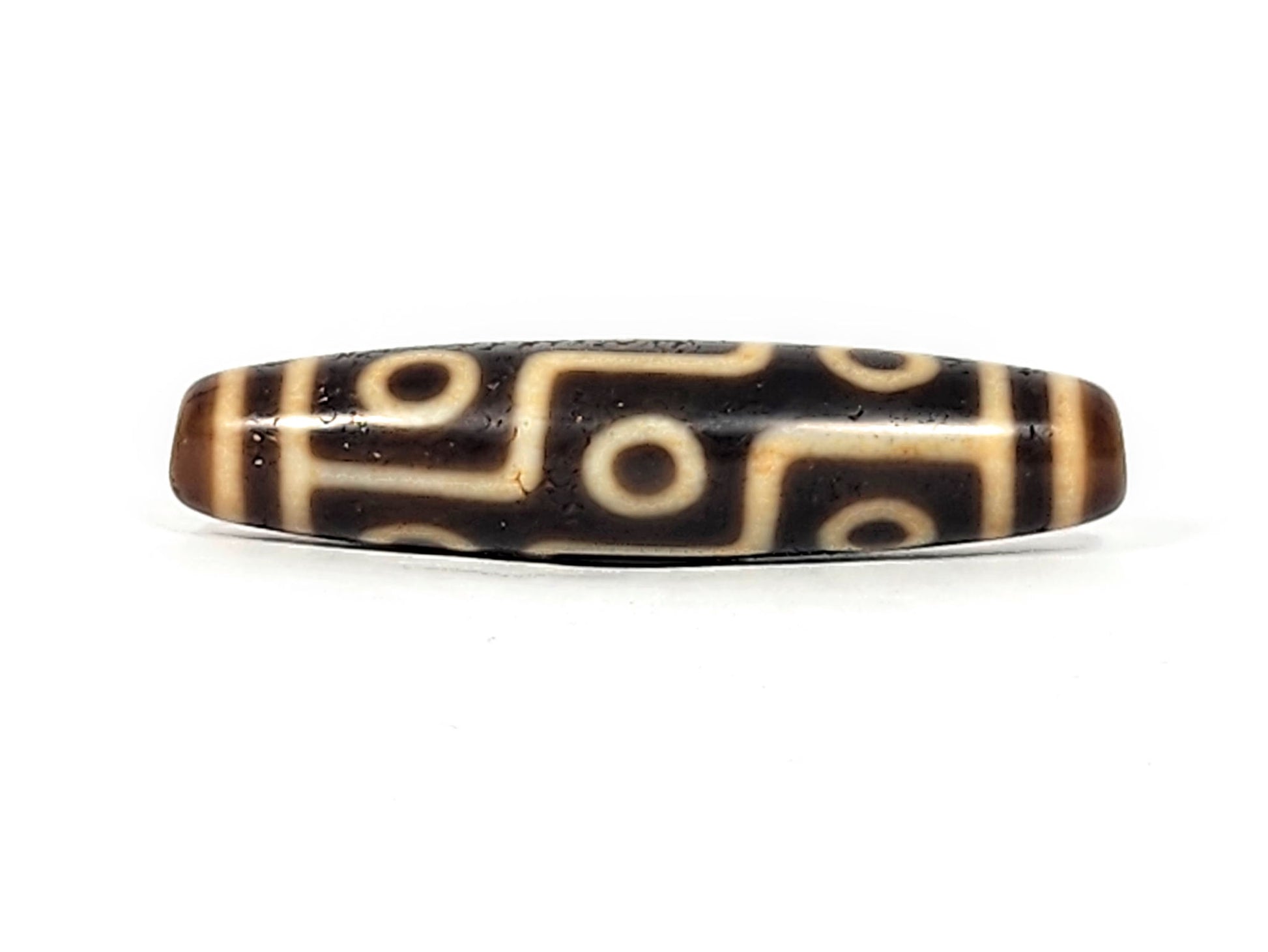 Antique Nine Eye dzi bead face B showing interconnected cream eye network on deep brown agate, At-011625-9E