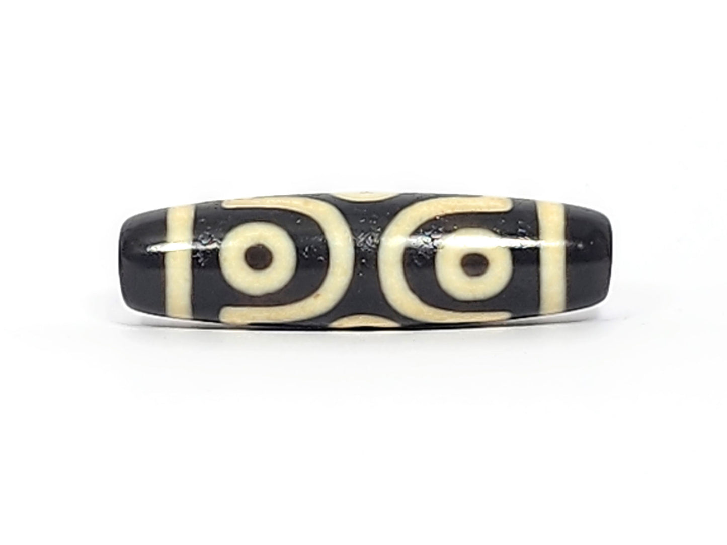 Antique six eye dzi At-042925-6E2, Face A, two open C-ring eyes with bold scroll connector on pitch-black agate, bright cream motif, 41.4mm × 11.4mm, unretouched
