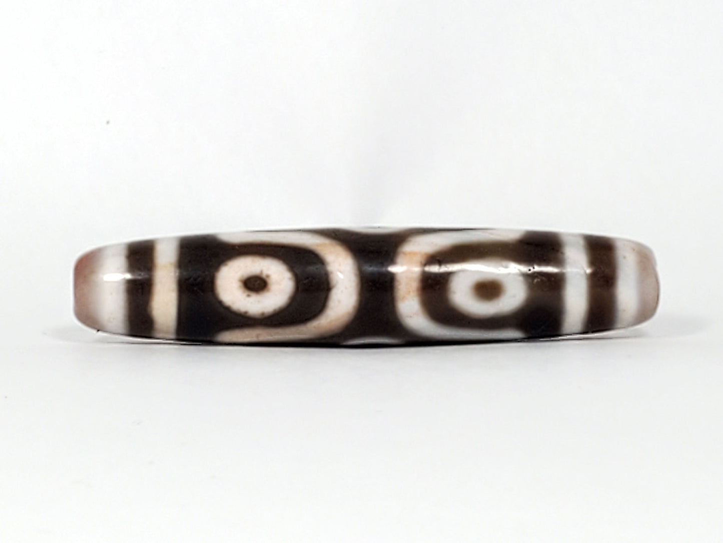 At-082824-6EBS2 face D two rounded open-ring eyes warm brown cinnabar tint dzi unretouched