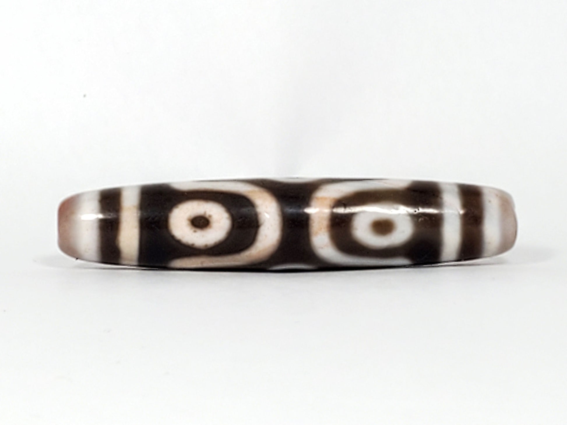 At-082824-6EBS2 face D two rounded open-ring eyes warm brown cinnabar tint dzi unretouched