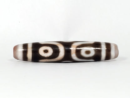 At-082824-6EBS2 face D two rounded open-ring eyes warm brown cinnabar tint dzi unretouched