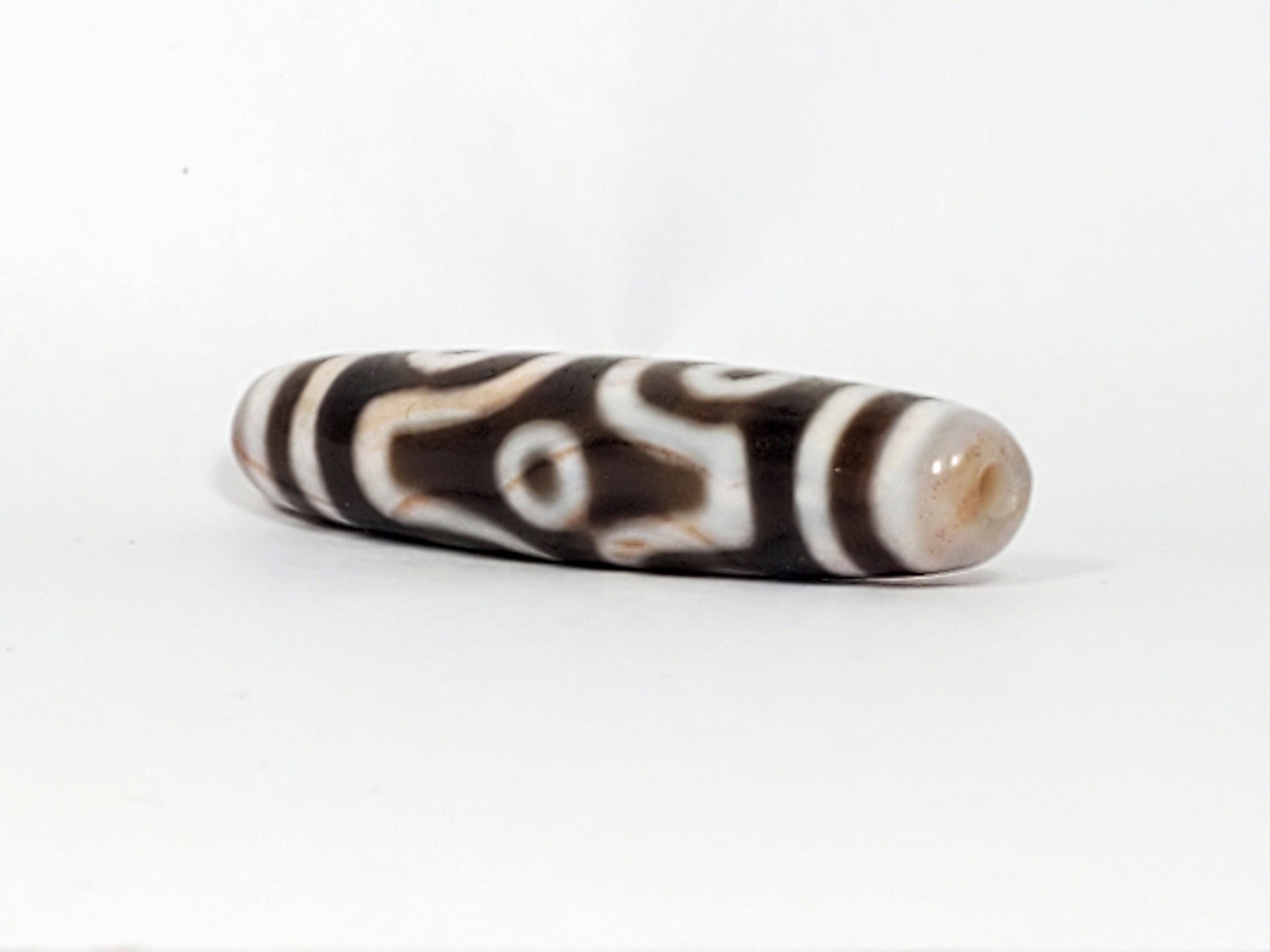 At-082824-6EBS2 end B sandy-cream cap slender spindle 57.7mm angular eye face visible dzi unretouched