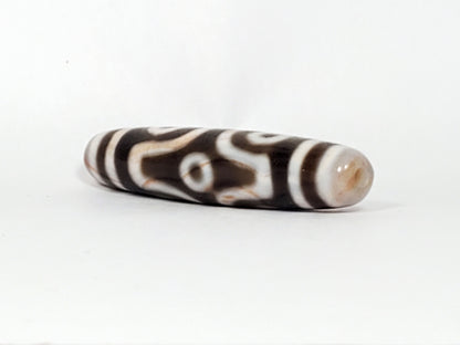 At-082824-6EBS2 end B sandy-cream cap slender spindle 57.7mm angular eye face visible dzi unretouched