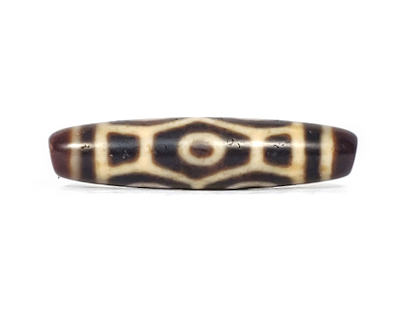 Antique Tibetan Naga dzi bead face D showing hexagonal body scale and central eye on dark agate, At-092524-6EN