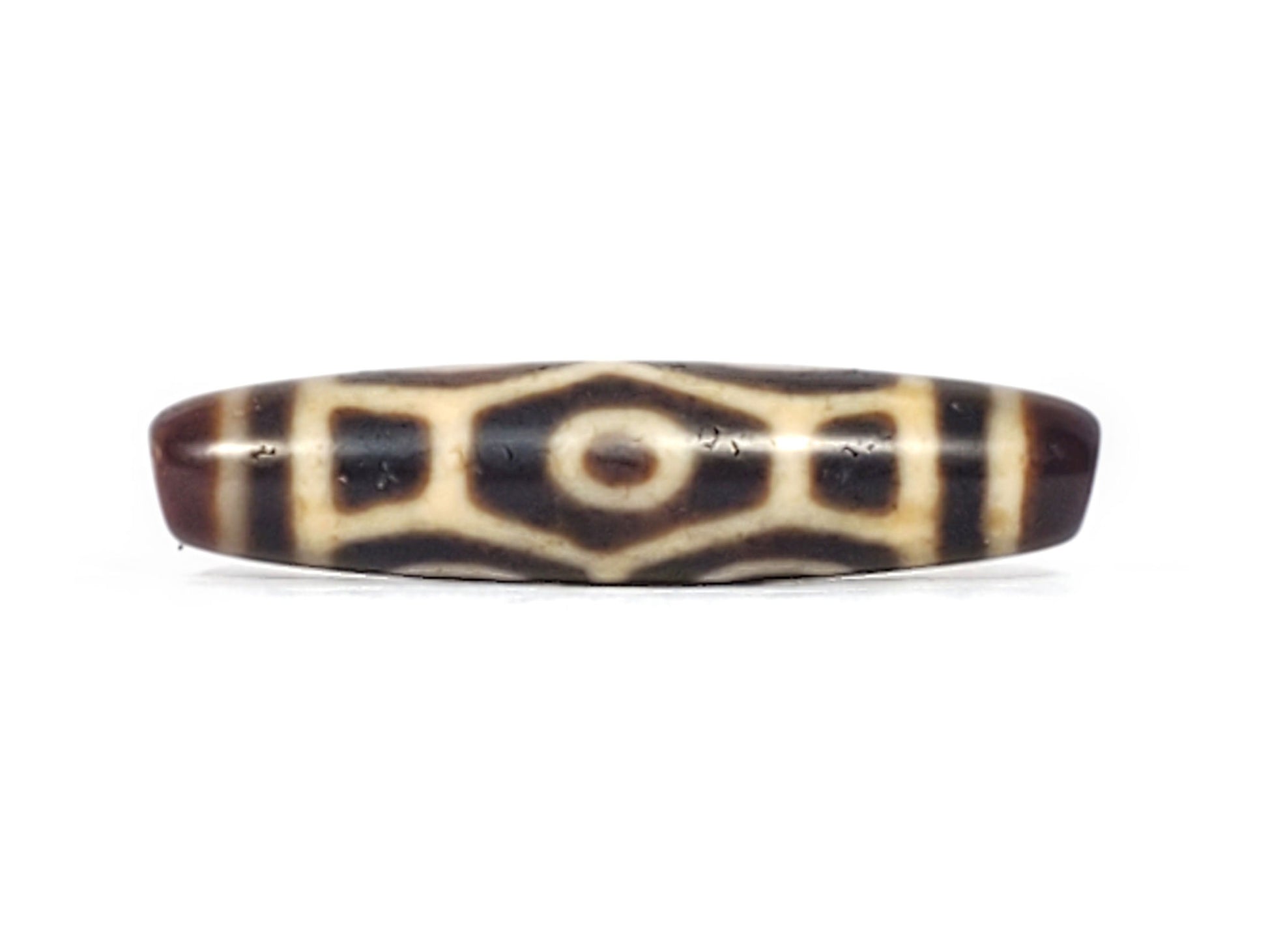 Antique Tibetan Naga dzi bead face D showing hexagonal body scale and central eye on dark agate, At-092524-6EN