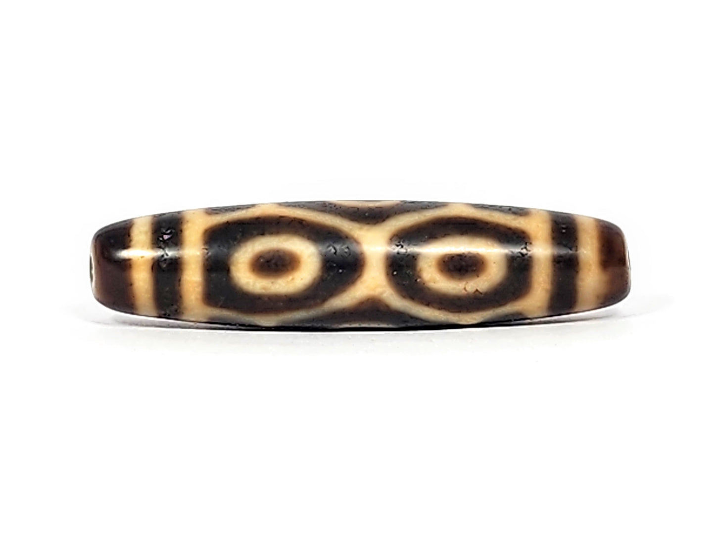 Antique Six Eye Naga dzi bead face C showing paired Dragon eyes with generous cream ring zones, At-122124-6EN2