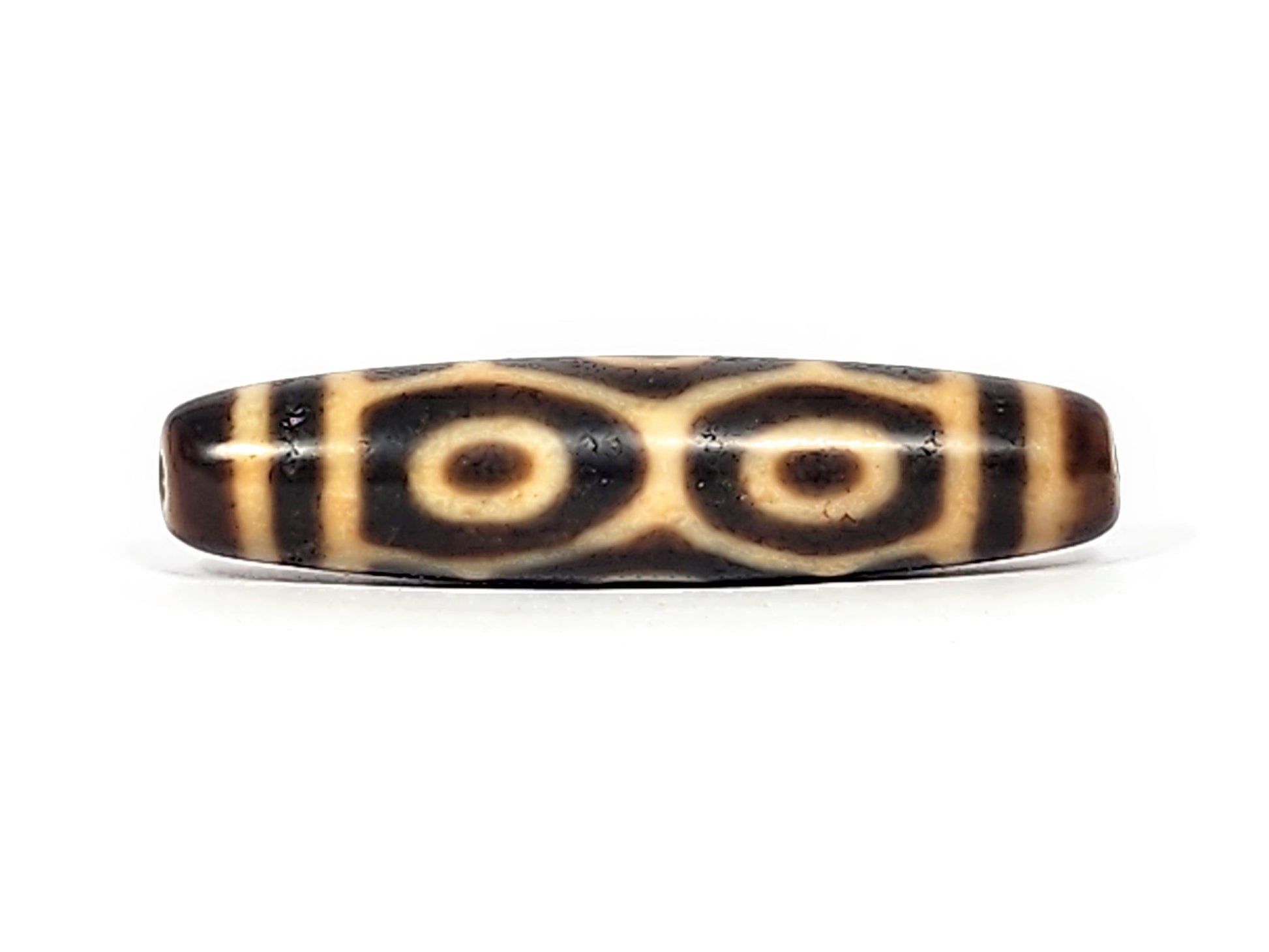 Antique Six Eye Naga dzi bead face C showing paired Dragon eyes with generous cream ring zones, At-122124-6EN2