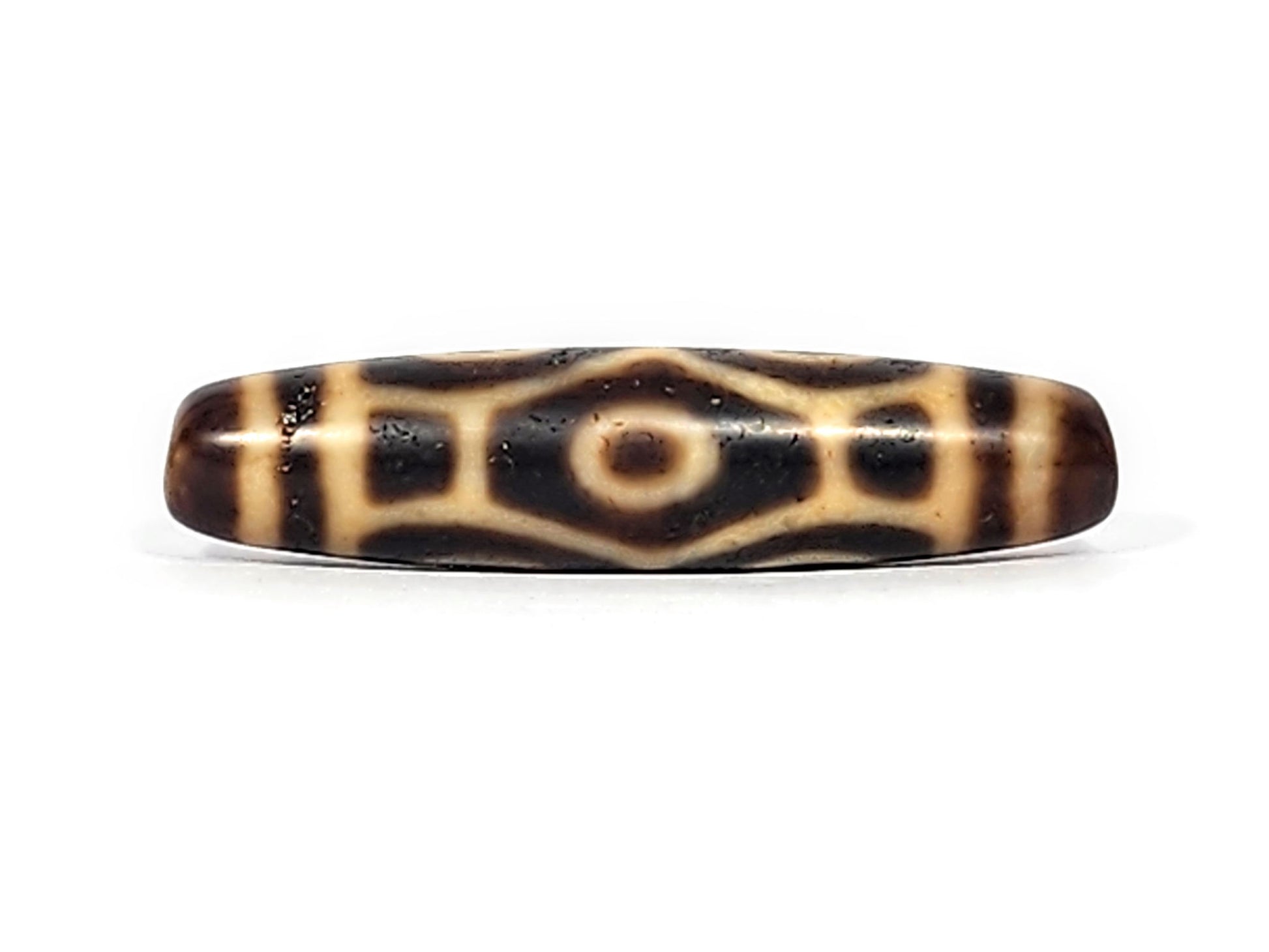Antique Tibetan Naga dzi bead face D showing elongated diamond body scale and single eye on brown agate, At-122124-6EN2