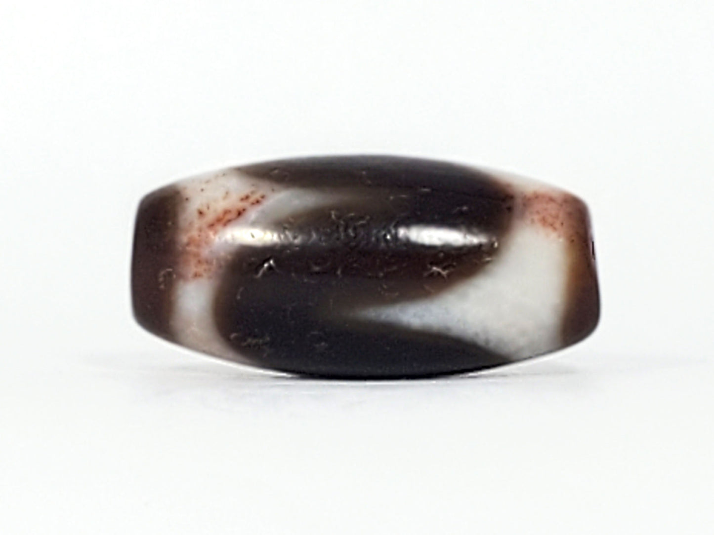 Antique Tibetan Tasso dzi bead At-093024-TaBS3, front face, broad cream wave on deep chocolate-brown agate, surface bloodspots visible, wide 29.4mm × 14.0mm barrel, unretouched