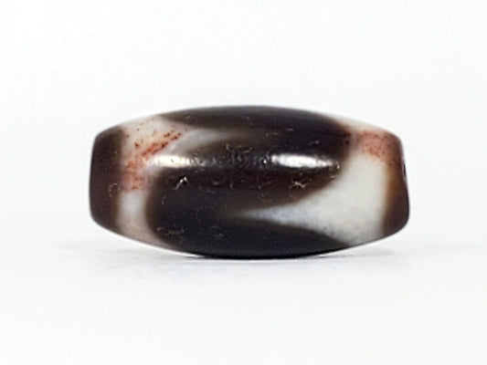 Antique Tibetan Tasso dzi bead At-093024-TaBS3, front face, broad cream wave on deep chocolate-brown agate, surface bloodspots visible, wide 29.4mm × 14.0mm barrel, unretouched