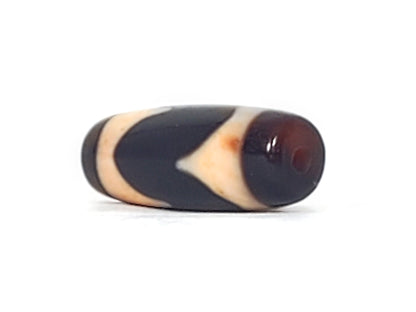 Opposite end cap of antique Tasso dzi At-092924-TaBS2, pitch-black agate tip, drill hole centred, cream Tasso zones with bloodspot inclusions visible, 28.7mm × 11.2mm