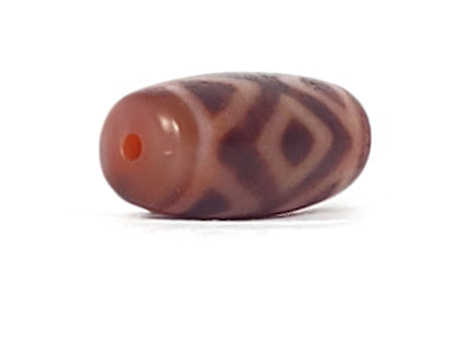 Opposite end cap of antique Three Diamond Eye Tiger Tooth dzi At-053126-3DETT, terracotta-red agate tip with bright orange drill hole, diamond motif body, unretouched photography