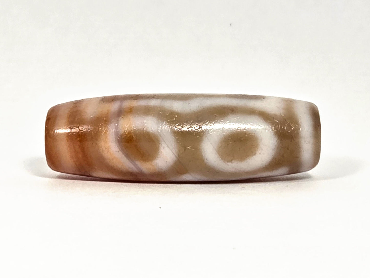 At-072326-3EVBS antique three eye variant dzi face C two oval eye rings warm brown ground unretouched