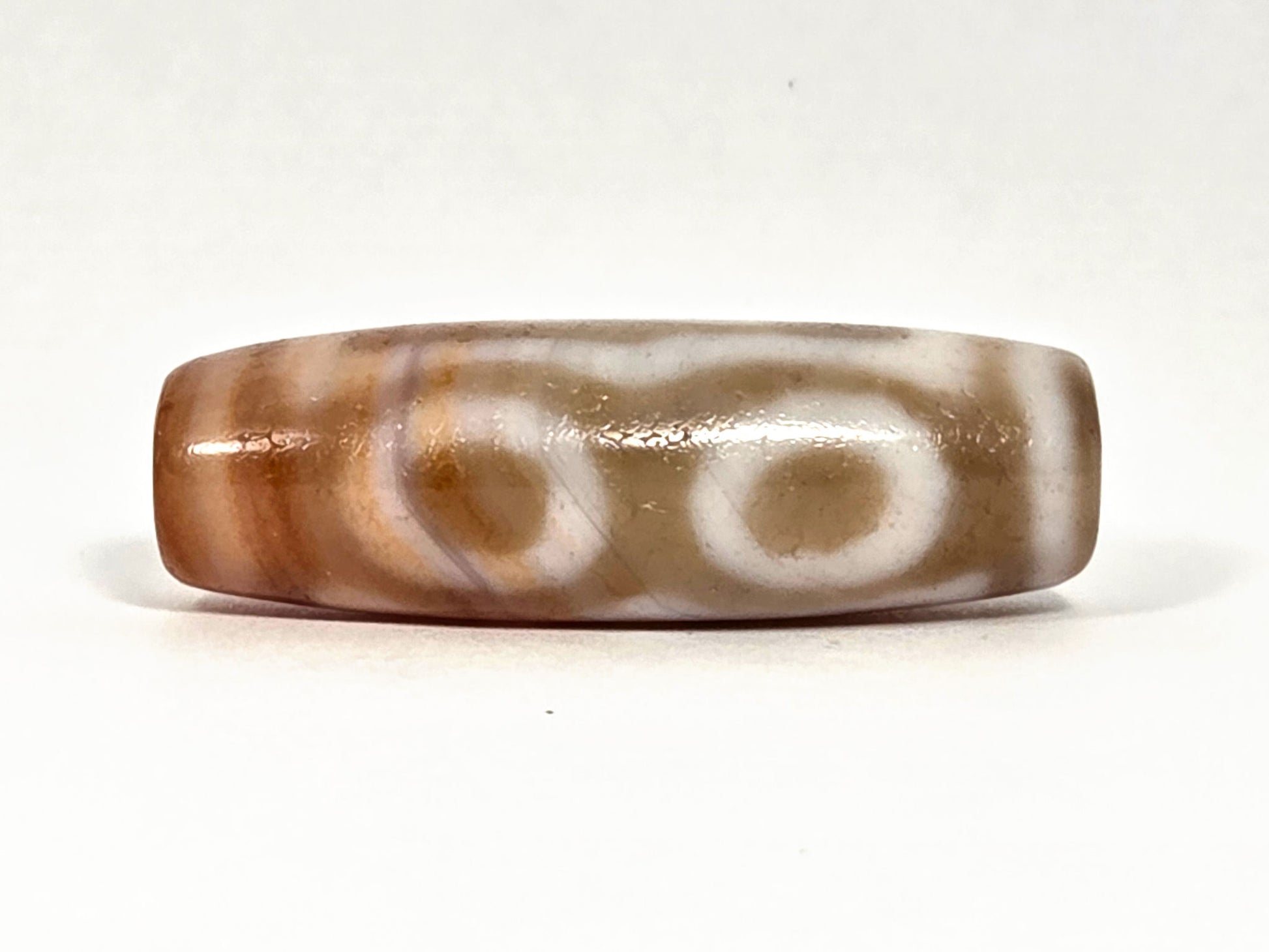 At-072326-3EVBS antique three eye variant dzi face C two oval eye rings warm brown ground unretouched