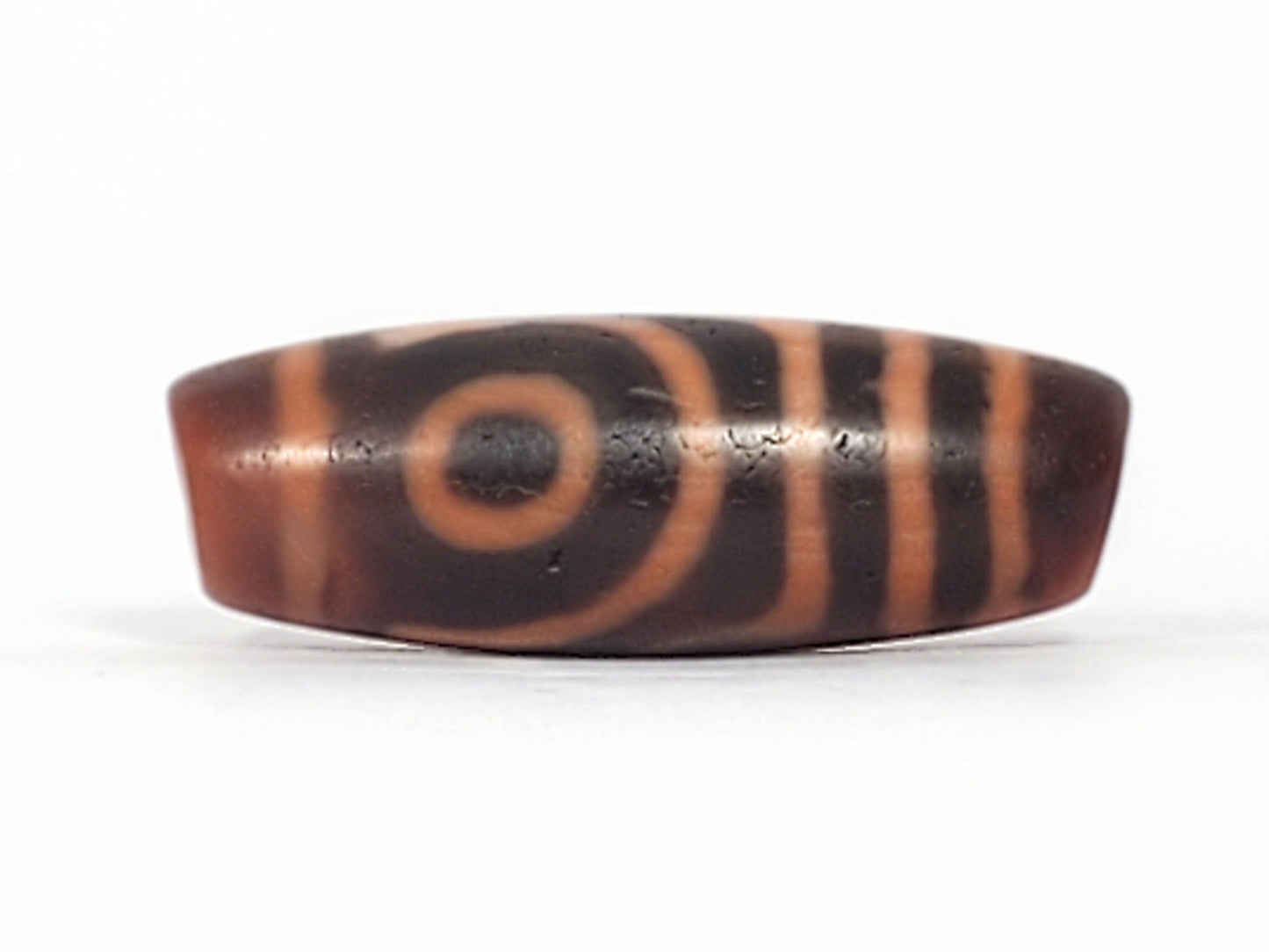 At-053126-2E6, second fully closed concentric eye, outer ring and dark pupil, mahogany-brown agate, unretouched