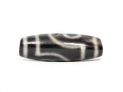 Alternate angle of antique two eye dzi At-033126-2E4, cream scroll wave motif on pitch-black agate, medicine dig face from different rotation, 37.3mm, unretouched