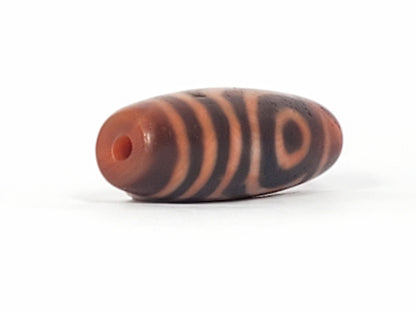 At-053126-2E6, second brick-red end cap with drilled hole, mahogany body, terracotta-orange motif, unretouched