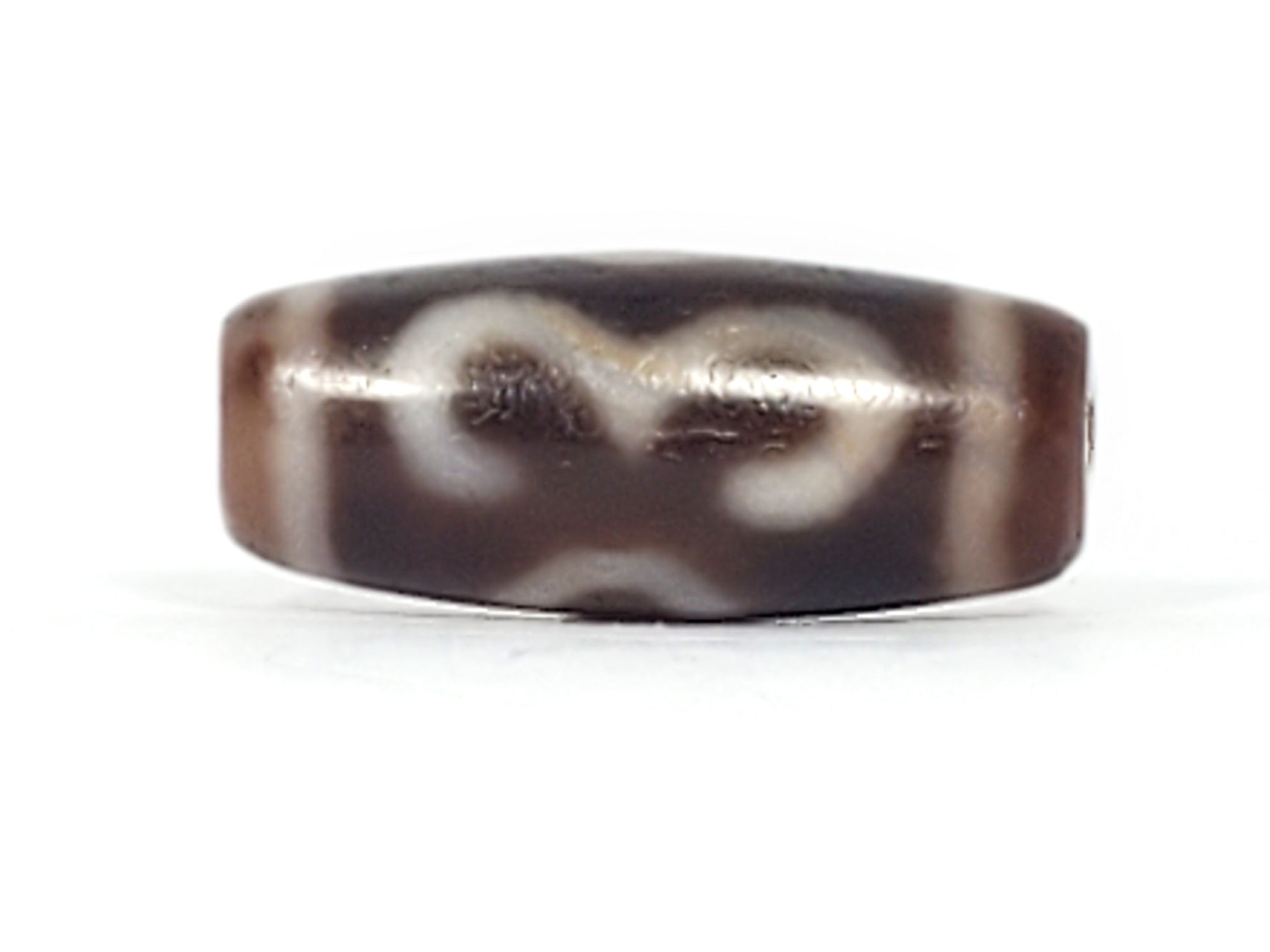 Antique Double Bat Two Eye dzi bead At-053026-DB2E, front face showing bat wing forms flanking eye rings in cream on dark brown agate, 28.8mm × 12.0mm, bloodspots, unretouched