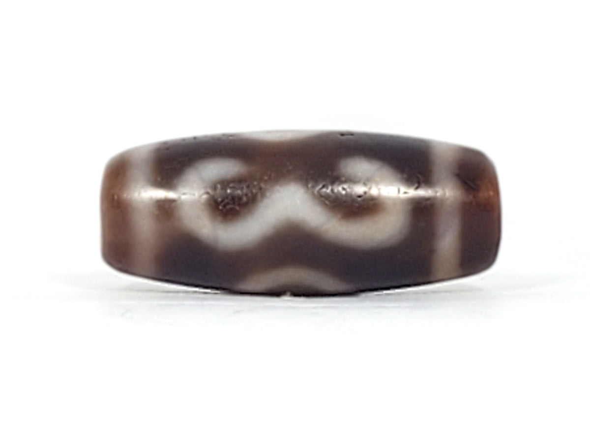 Third angle of antique Double Bat Two Eye dzi At-053026-DB2E, stylised bat wing silhouette with integrated two-eye motif, deep dark brown agate, 28.8mm × 12.0mm, unretouched