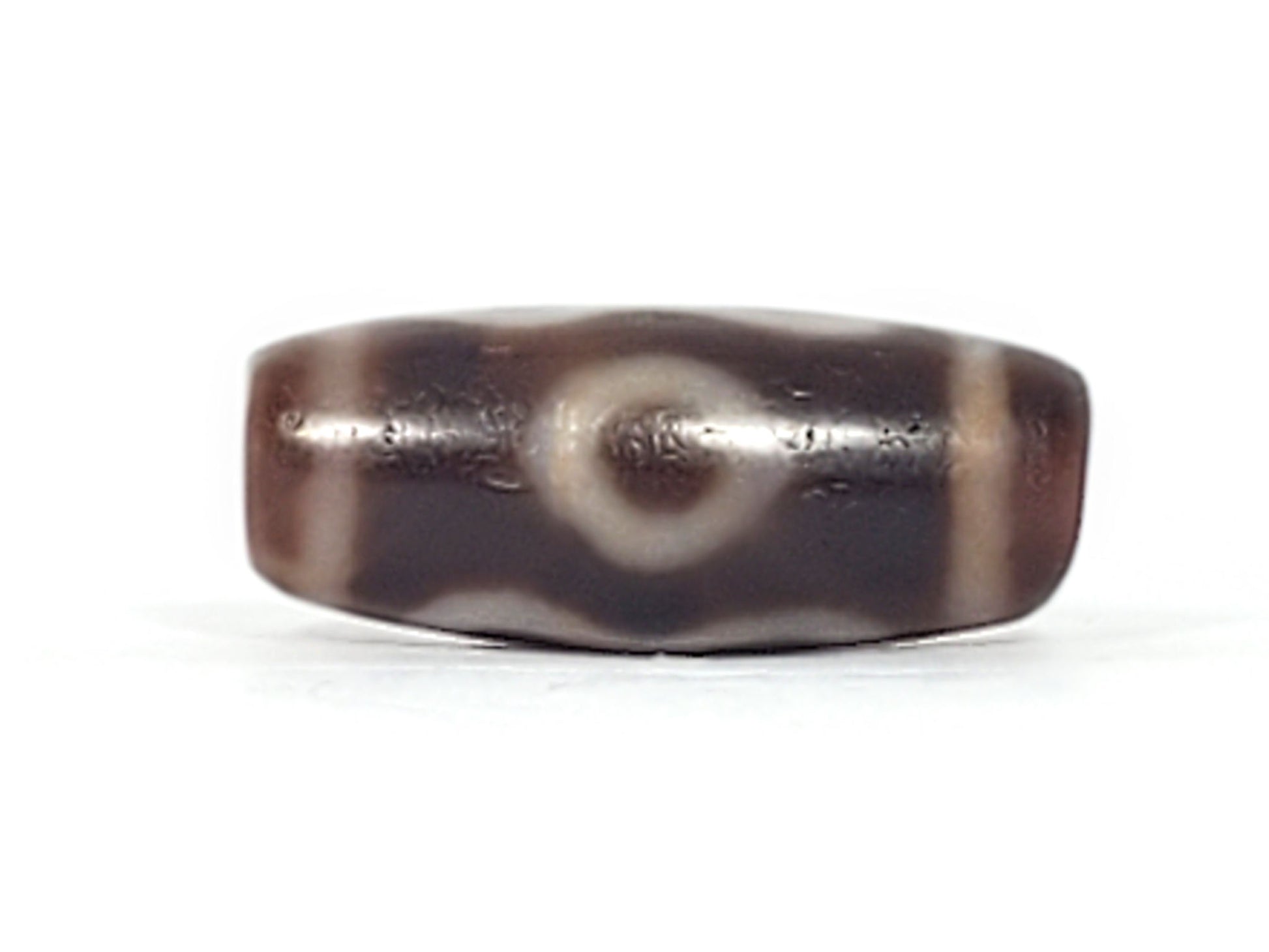 Fourth angle of antique Double Bat Two Eye dzi At-053026-DB2E, compact barrel form, cream bat and eye composition on dark brown agate ground, natural bloodspots, unretouched