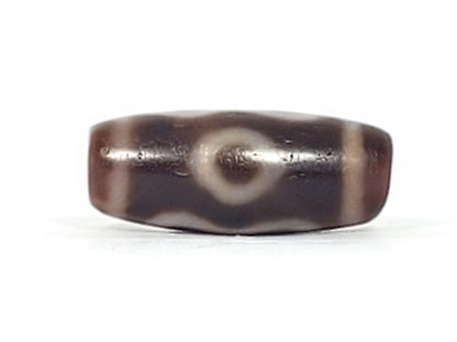 Fourth angle of antique Double Bat Two Eye dzi At-053026-DB2E, compact barrel form, cream bat and eye composition on dark brown agate ground, natural bloodspots, unretouched