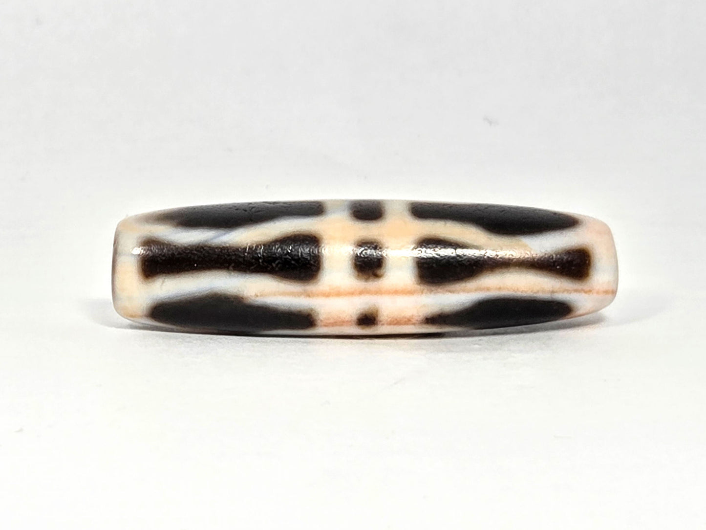 At-070626-3VjBS rotated face 4, triple vajra dzi, cream-white ground, dark brown motif, warm cinnabar tone, unretouched