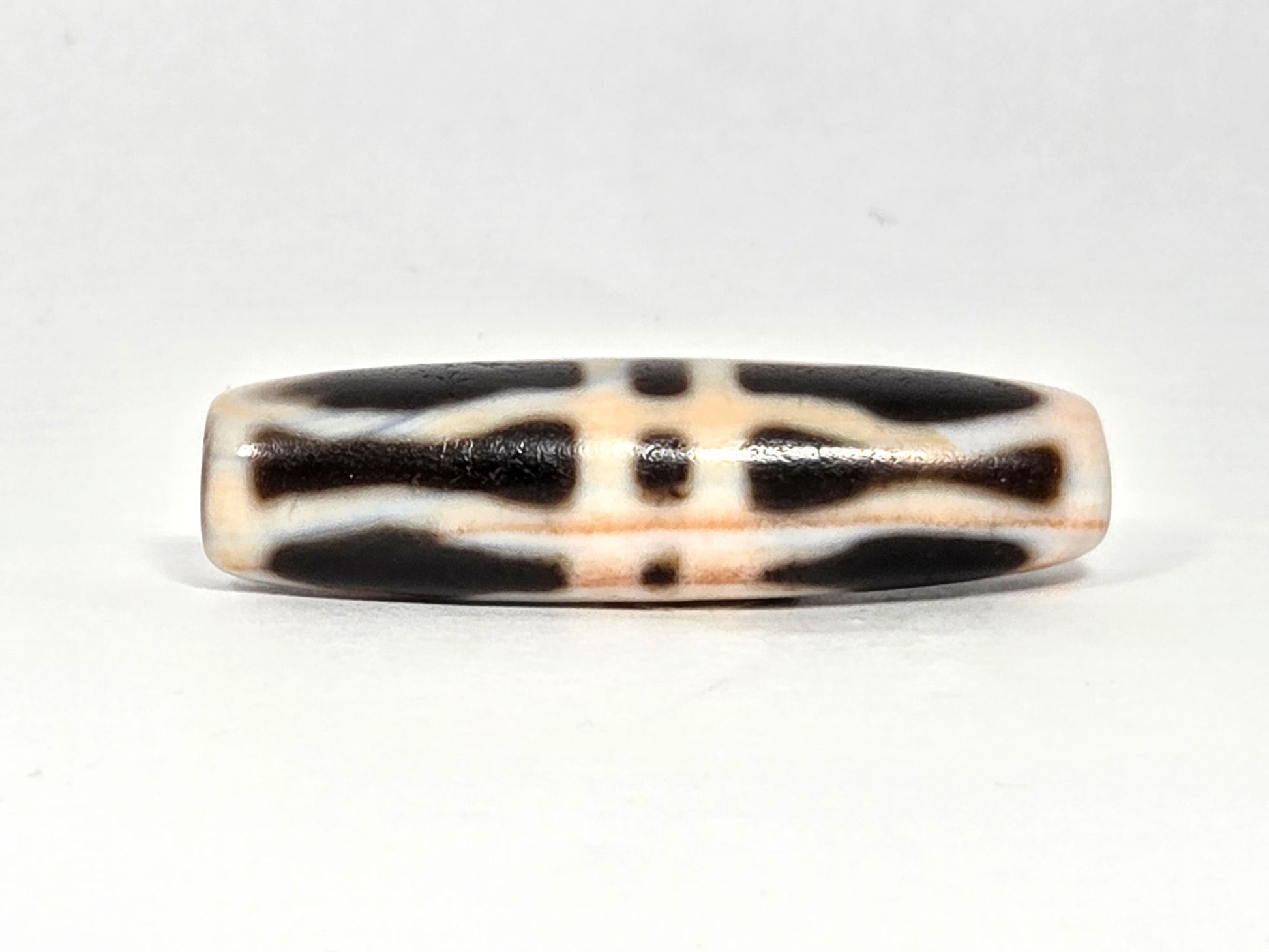 At-070626-3VjBS rotated face 4, triple vajra dzi, cream-white ground, dark brown motif, warm cinnabar tone, unretouched