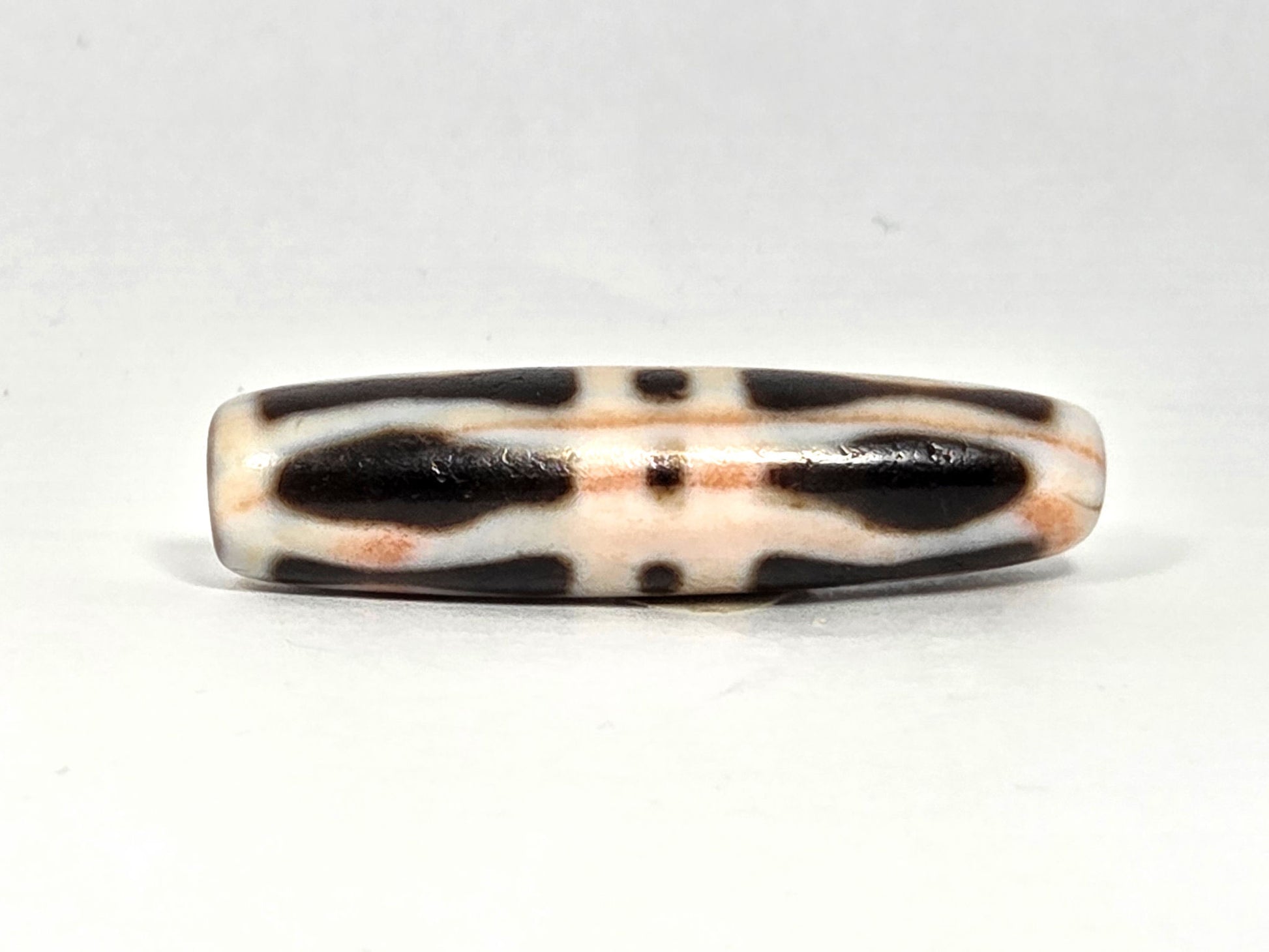 At-070626-3VjBS rotated face 5, triple vajra dzi, cream-dominant, warm terracotta cinnabar cast, unretouched