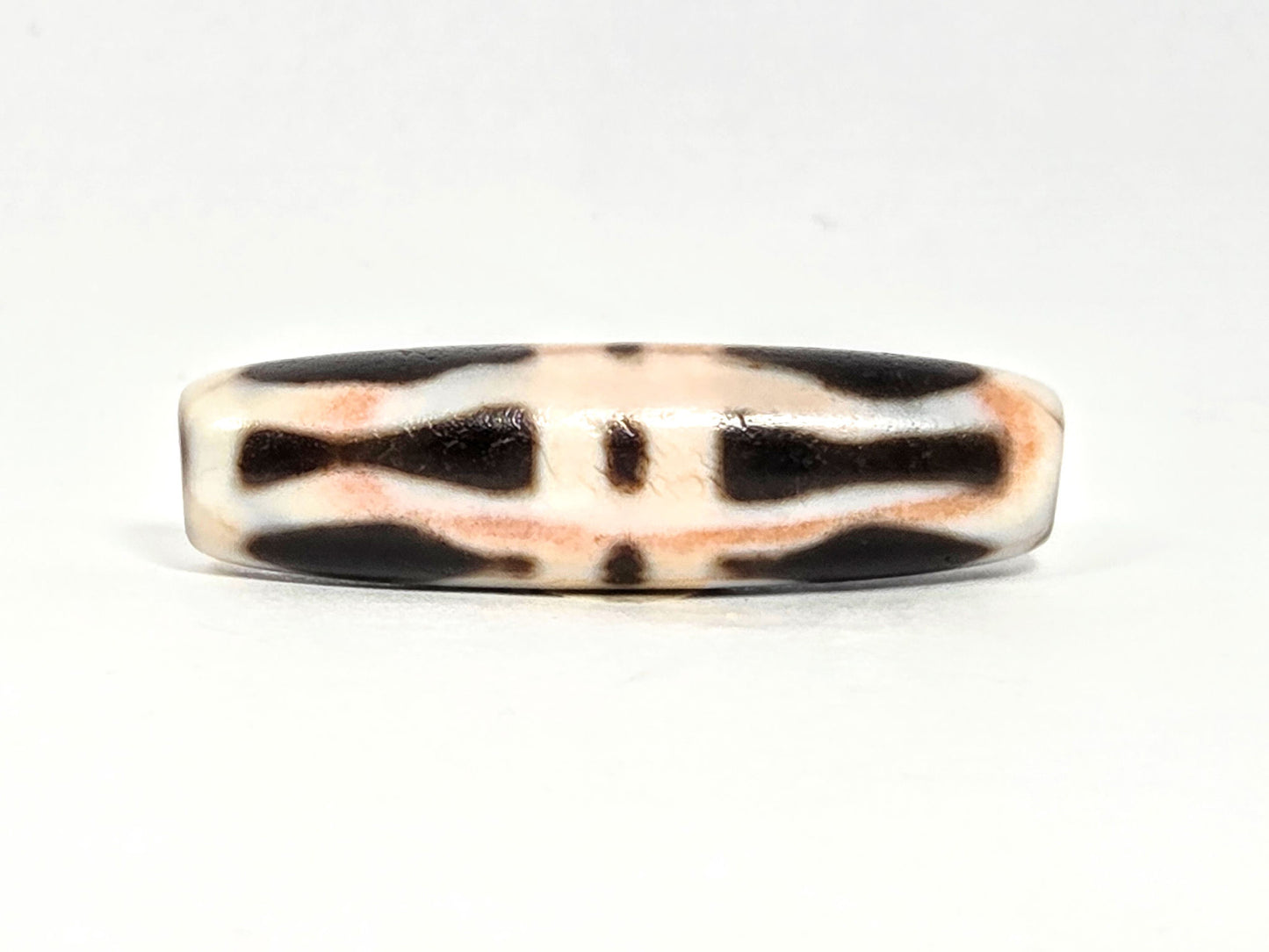 At-070626-3VjBS rotated face 6, triple vajra dzi, dark brown upper band, cream-white body, warm cinnabar tones, unretouched