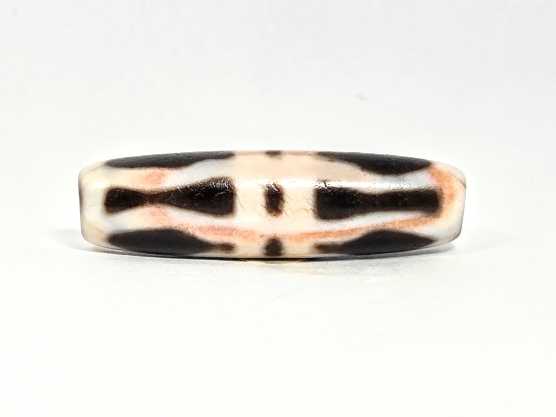 At-070626-3VjBS rotated face 6, triple vajra dzi, dark brown upper band, cream-white body, warm cinnabar tones, unretouched