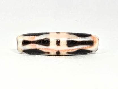 At-070626-3VjBS rotated face 6, triple vajra dzi, dark brown upper band, cream-white body, warm cinnabar tones, unretouched