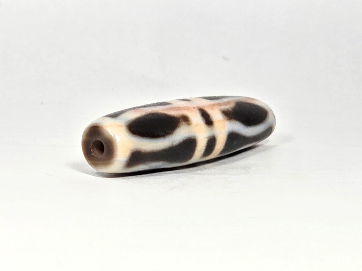At-070626-3VjBS opposite drill-end angled, triple vajra dzi, cream-white end cap, dark body bands, unretouched