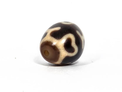 At-080926-4ELT antique round dzi bead 19.9×16.6mm, rotation E side view showing cream cross element and warm translucent drill end zone, unretouched