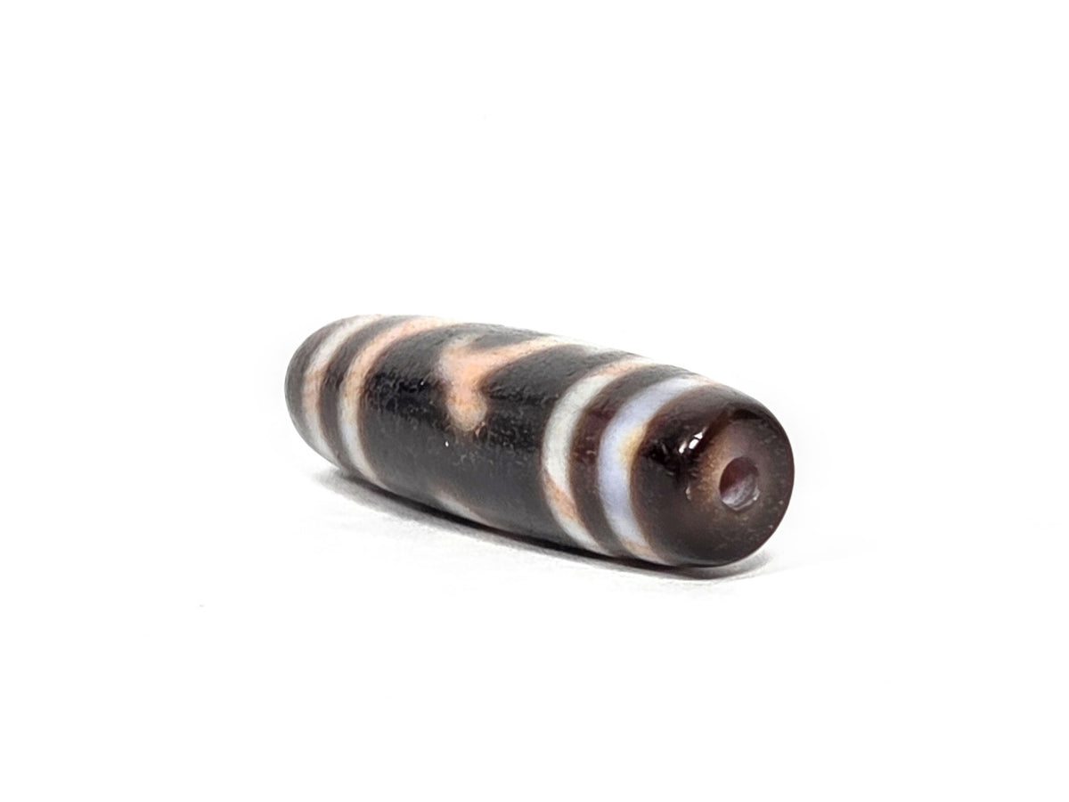 At-080426-GTBS2 antique Green Tara dzi bead 37.8×10.8mm, opposite drill-end angled view showing cream-grey-brown agate end cap and body profile, unretouched