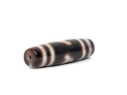 At-080426-GTBS2 antique Green Tara dzi bead 37.8×10.8mm, angled drill-end view showing warm dark brown agate end cap and fusiform taper, unretouched
