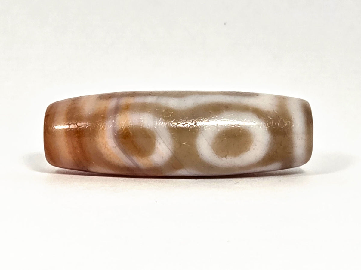 At-072326-3EVBS antique three eye variant dzi face C two oval eye rings warm brown ground unretouched