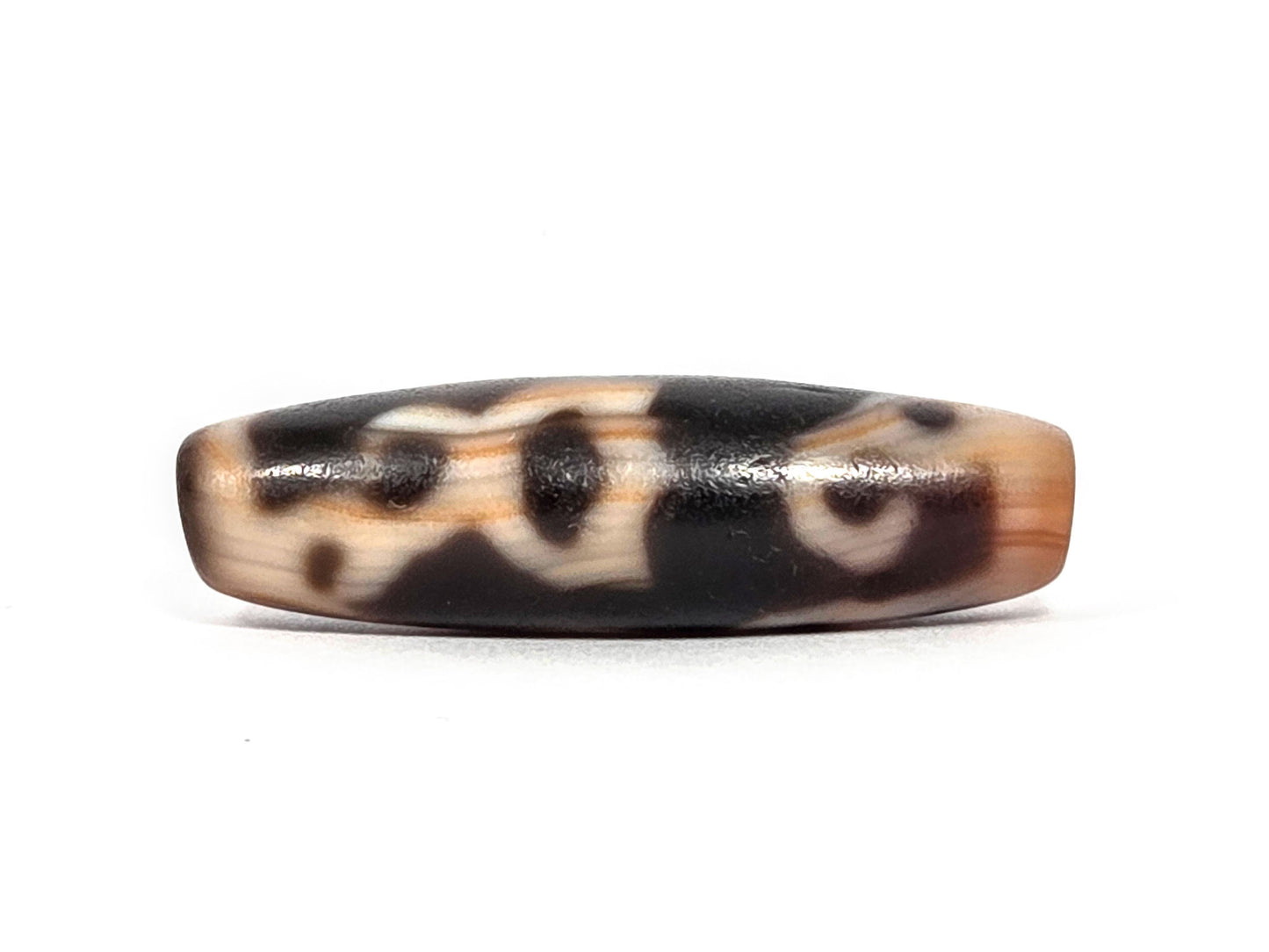At-072226-LBBS Lotus Bud bloodspot face C — broad cream zones, dark brown patches, transitional motif reading, unretouched. 