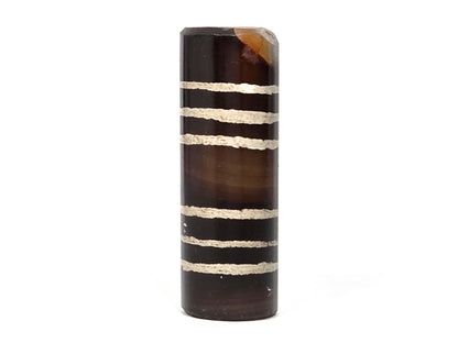Ac-062226-6Str, front-face view showing all six sandy-cream stripes, warm dark brown ground, chip at top, unretouched