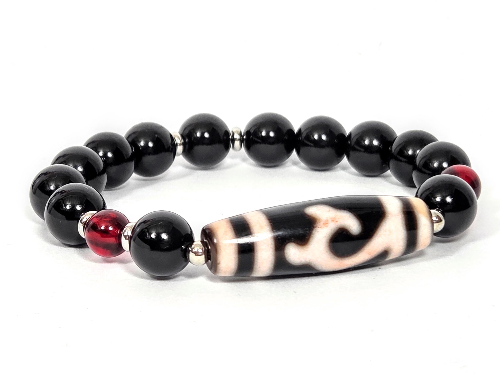 Bracelet featuring antique Tibetan Green Tara Dzi bead with bloodspots, 37.3mm, flanked by 10.5mm black agate rounds and 7.5mm red amber beads with silver spacers — unretouched photo — Ancient Dzi Shop