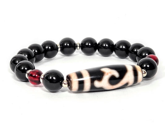 Bracelet featuring antique Tibetan Green Tara Dzi bead with bloodspots, 37.3mm, flanked by 10.5mm black agate rounds and 7.5mm red amber beads with silver spacers — unretouched photo — Ancient Dzi Shop