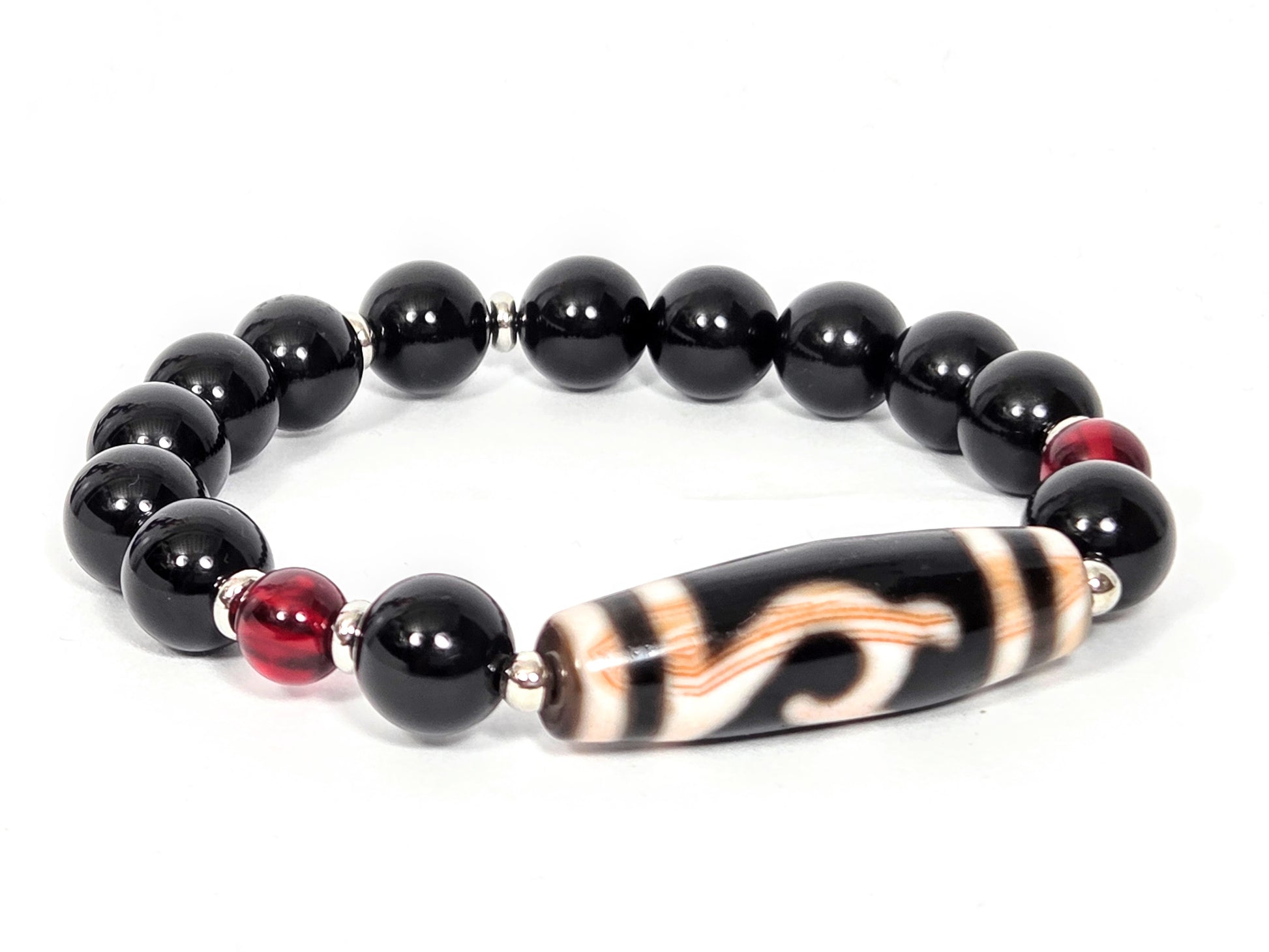 Reverse side of bracelet featuring antique Green Tara Dzi bead with natural amber striations, black agate and red amber accent beads — unretouched photo — Ancient Dzi Shop