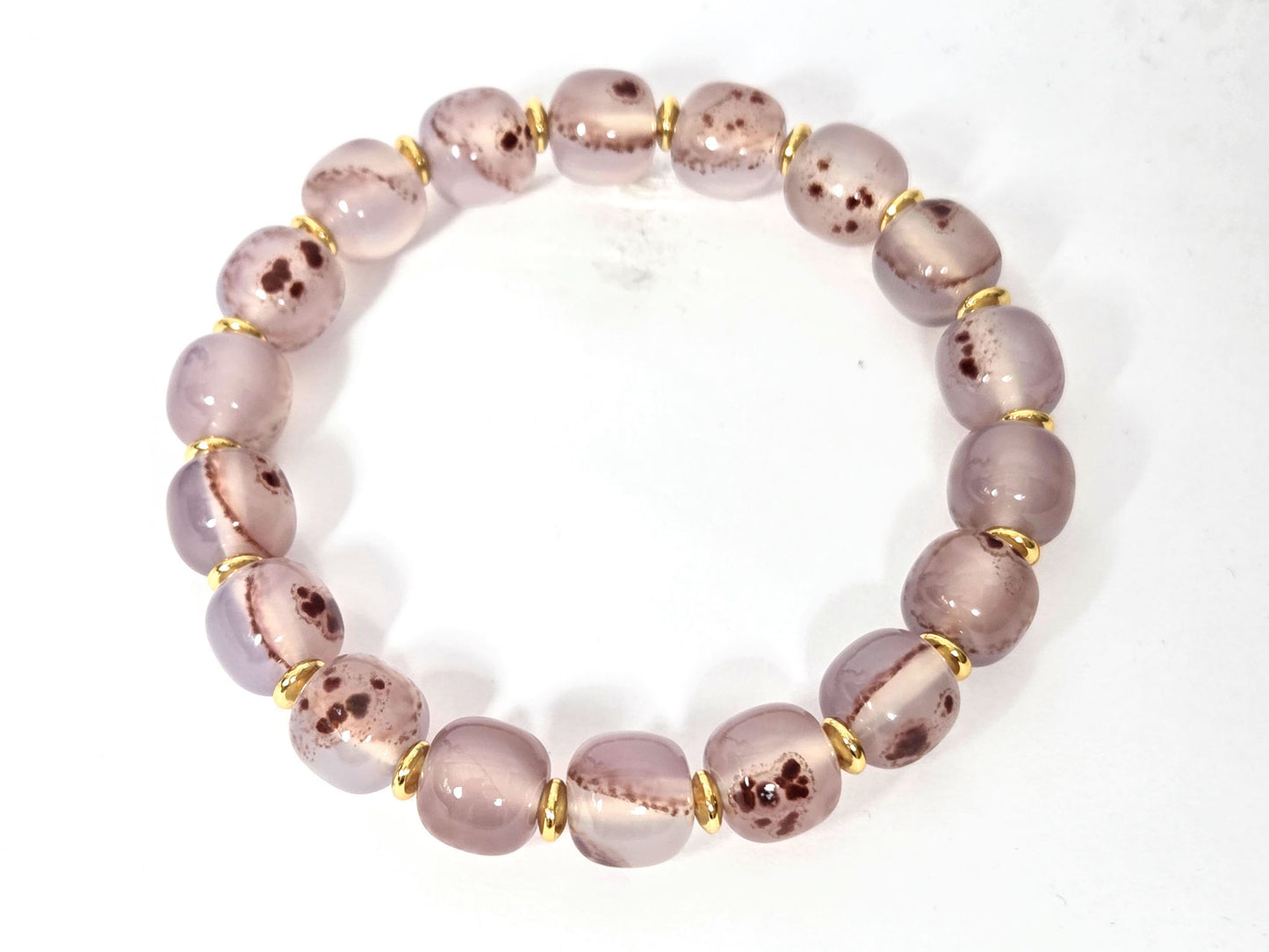 N-030526-CB2 chalcedony bracelet overhead, round mauve-rose beads, gold rondelle spacers, cinnabar inclusions, unretouched