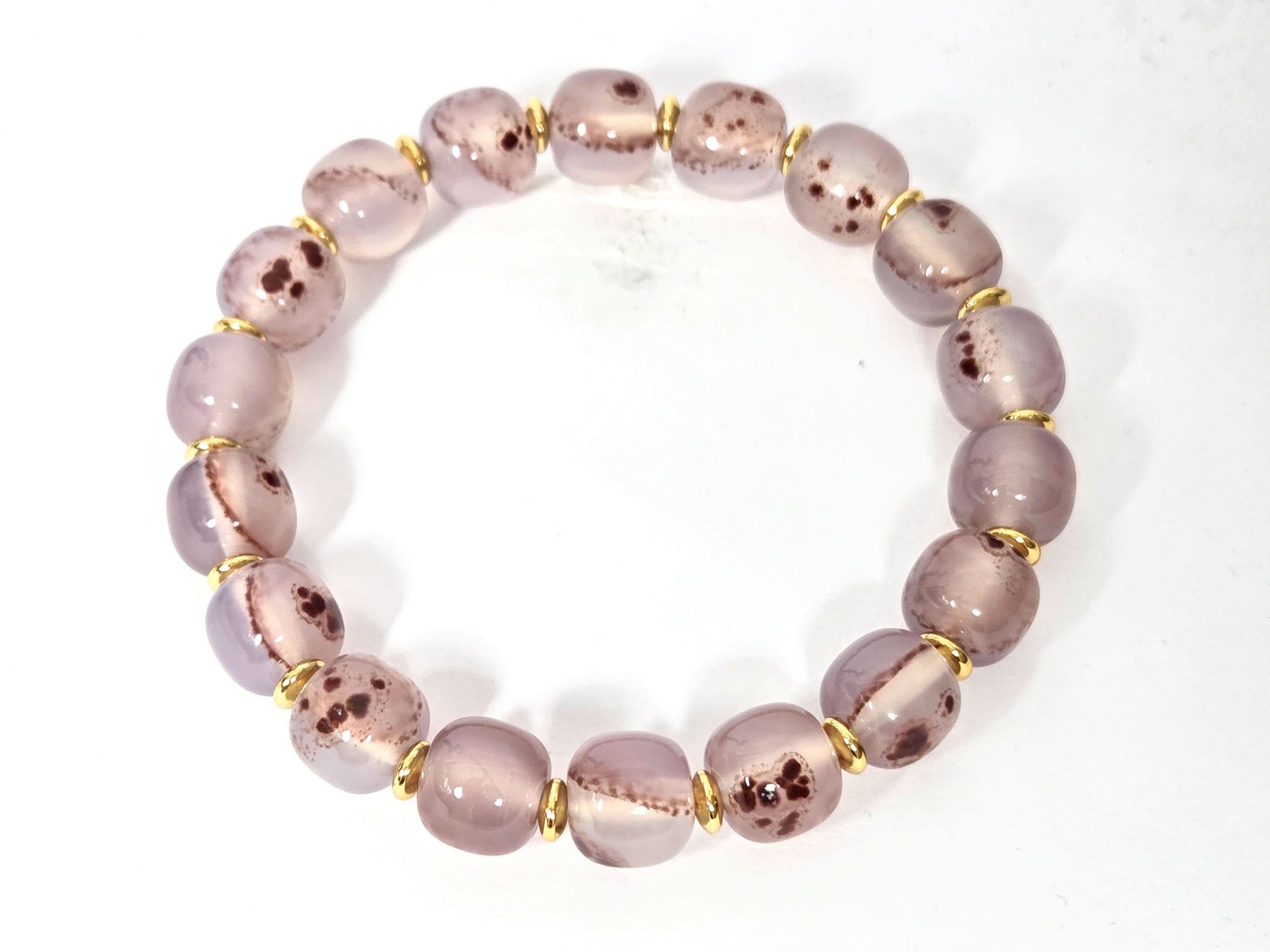 N-030526-CB2 chalcedony bracelet overhead, round mauve-rose beads, gold rondelle spacers, cinnabar inclusions, unretouched